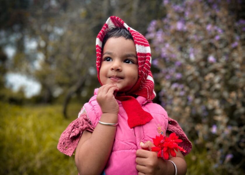 A Girl Wearing a Pink Baby Vest