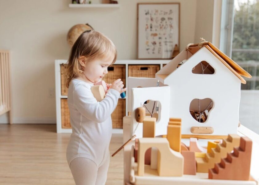 a baby playing wooden baby toys